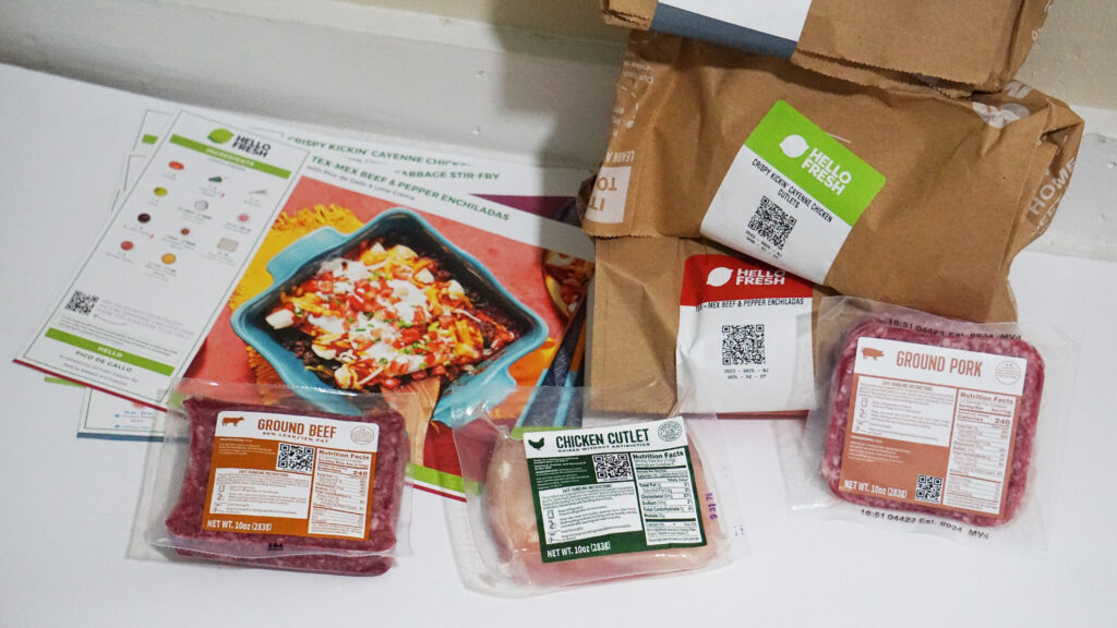 HelloFresh ingredients sorted into labeled paper bags for each recipe