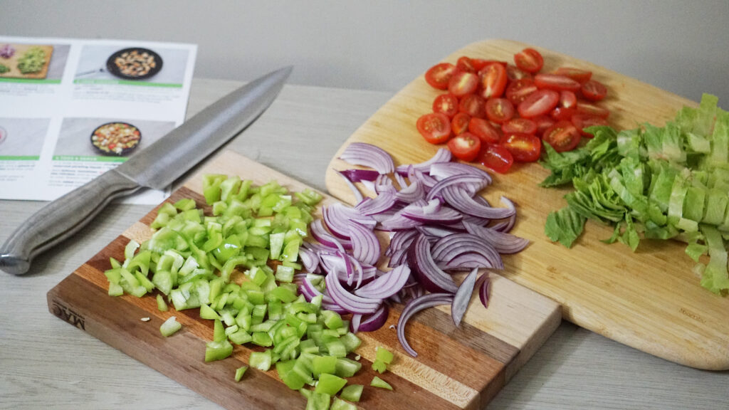Chopped ingredients on a cutting board for HelloFresh Diner-Style Greek Salad with Chicken