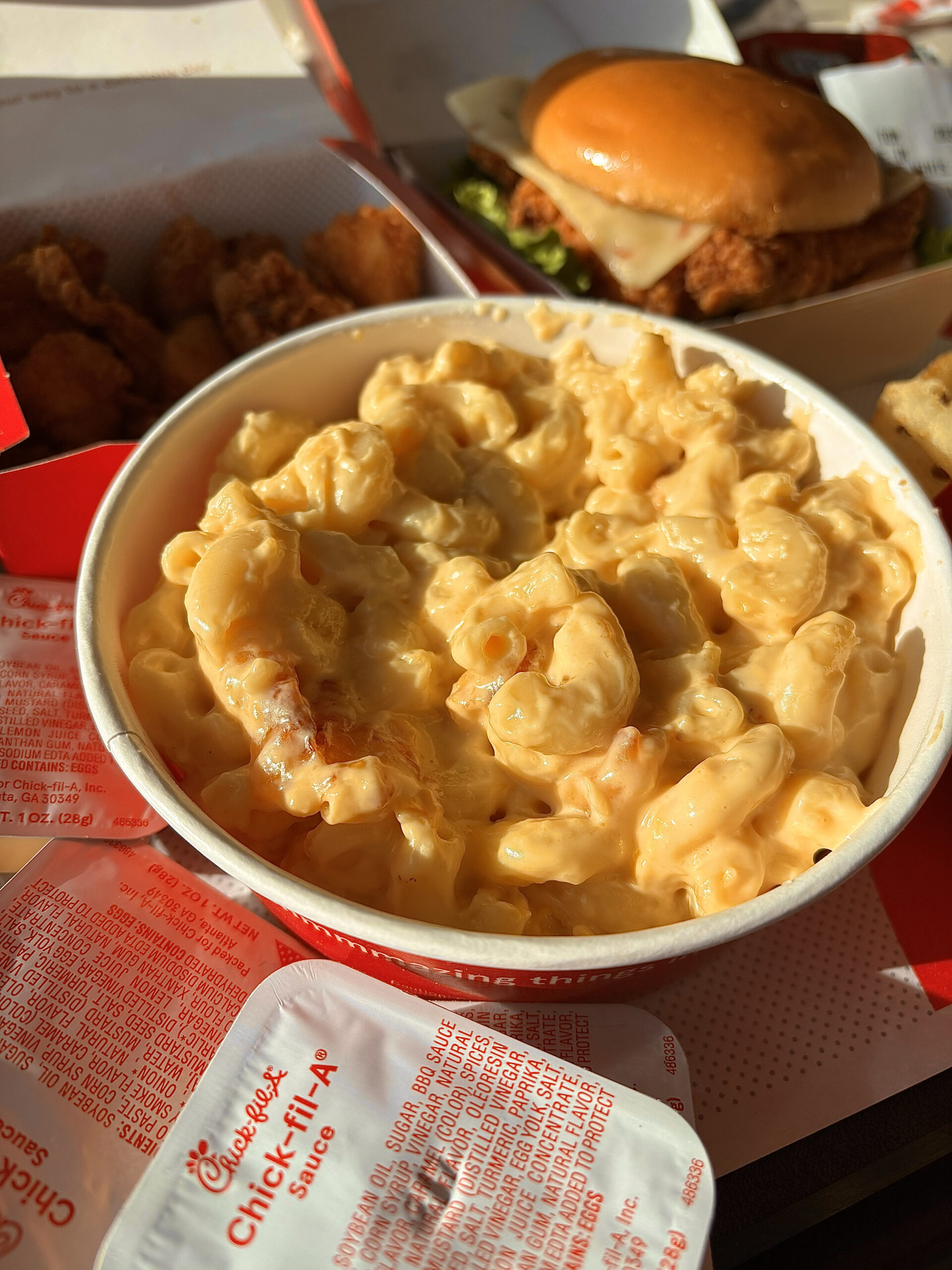Chick-fil-A mac and cheese served on a tray with nuggets and a chicken sandwich.