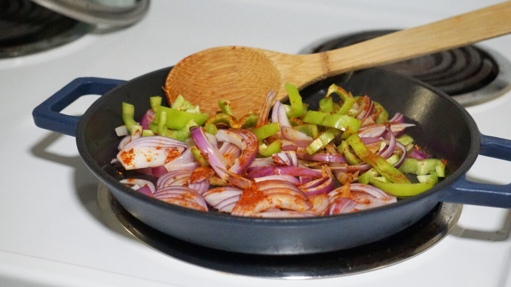 Cooking HelloFresh One-Pan Cantina Shrimp Fajitas in a skillet