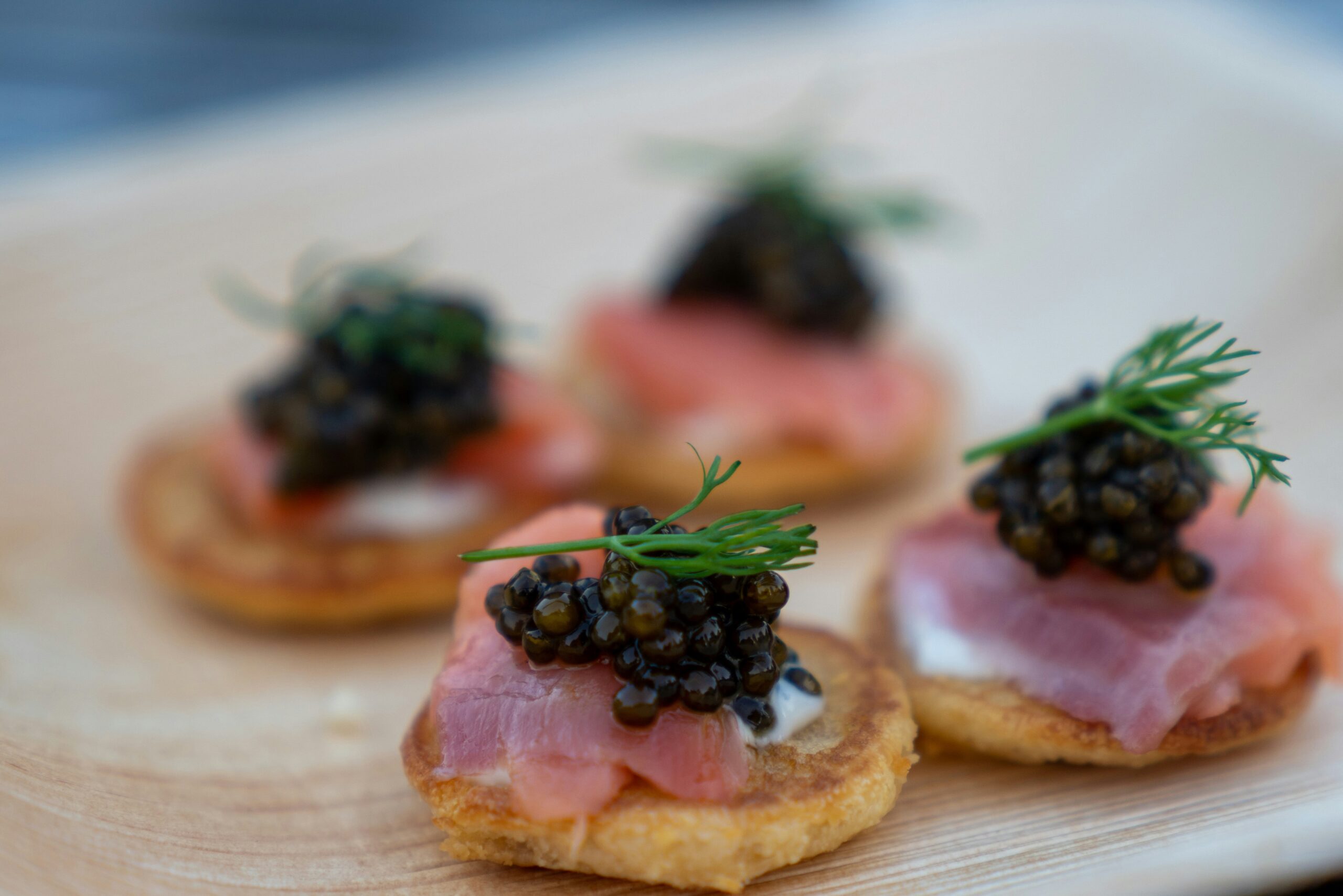 Imitation caviar made with lentils served on crostini with crème fraîche, lox, dill, and caviar-style lentils