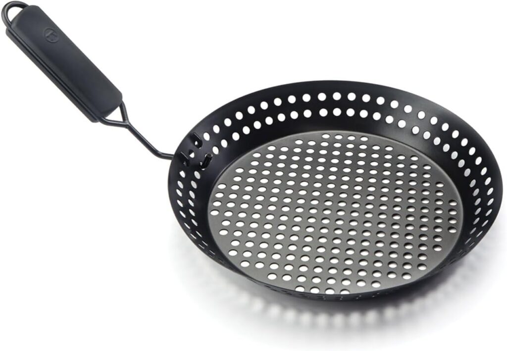 Perforated grill skillet with evenly spaced holes used to make crispy stovetop pizza by allowing direct heat to reach the pizza crust.