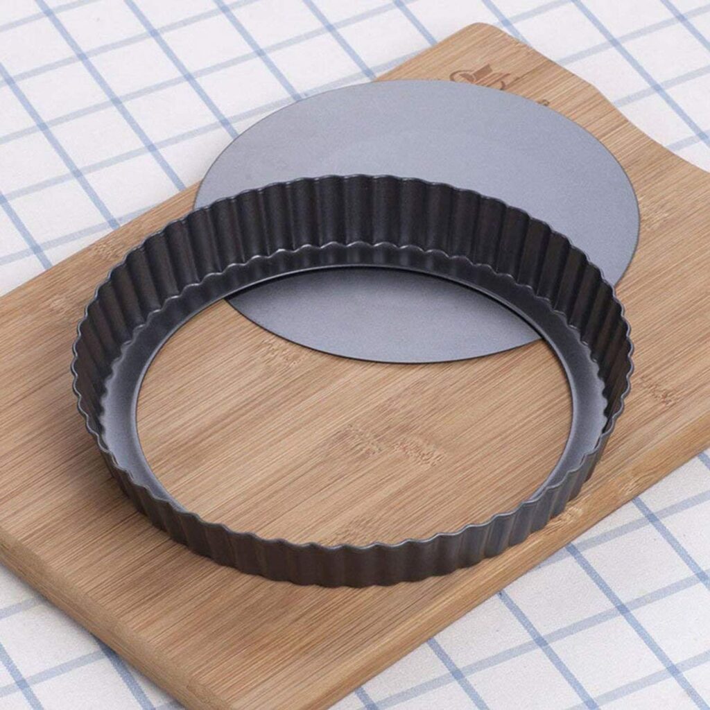 Metal tart pan with removable bottom ideal for baking gluten-free potato crust quiche with crisp edges.