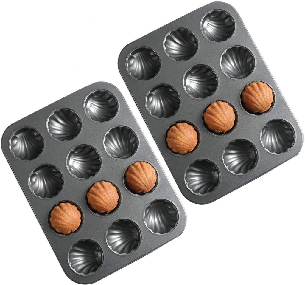 Seashell-shaped madeleine baking pan with scalloped shell molds for creating beach-themed cakes and desserts.