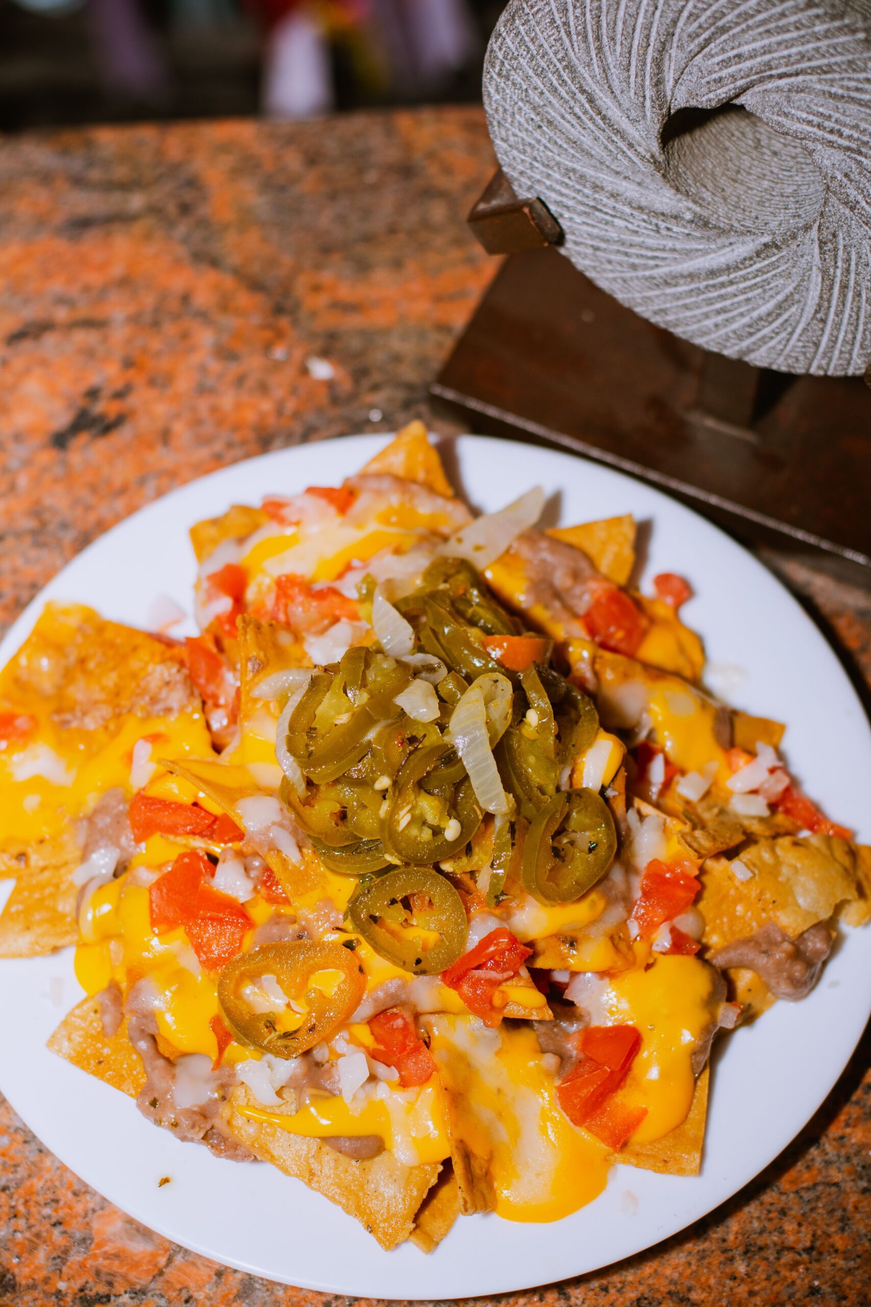 Loaded nachos topped with creamy vegan sweet potato nacho cheese sauce.